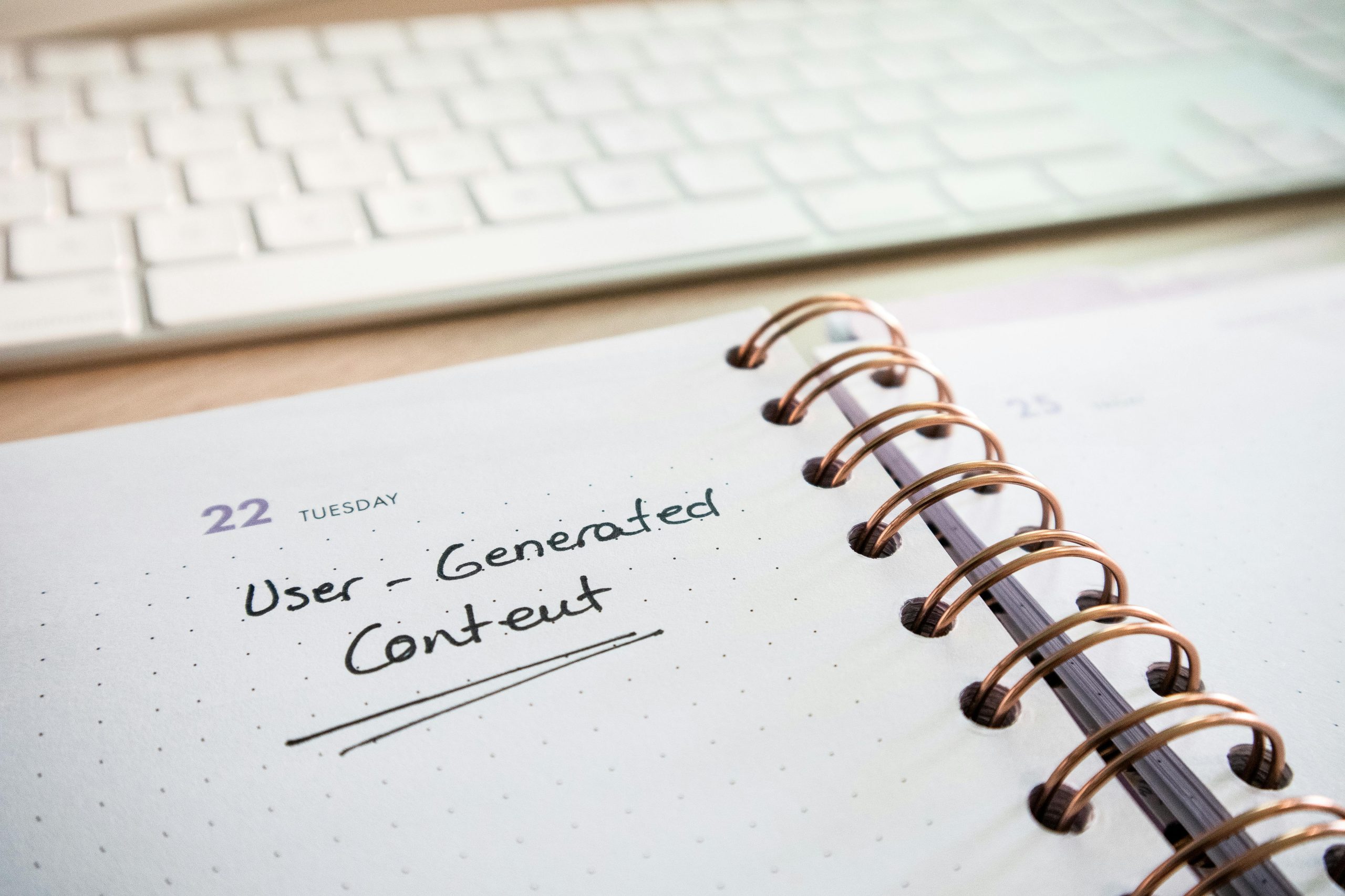 Notebook with user-generated content note and keyboard, ideal for planning and productivity.